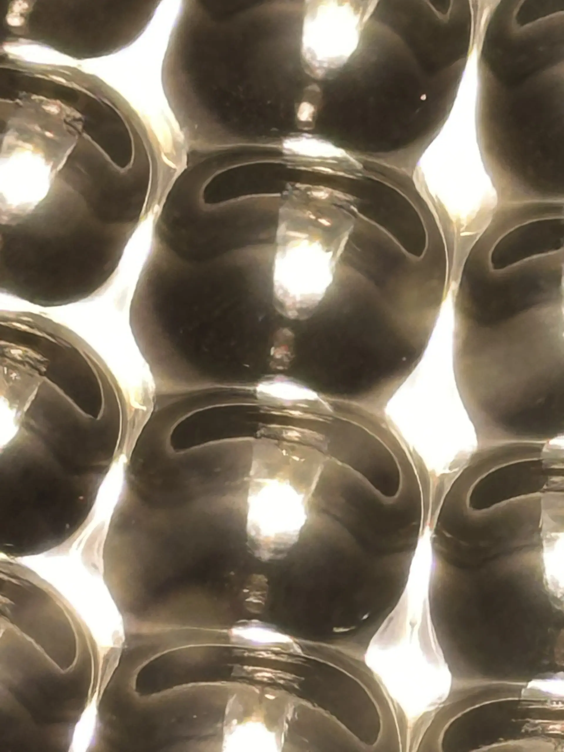Close-up photograph of repeated reflective cells on the Nano Grow Light reflector; no calibrated scale