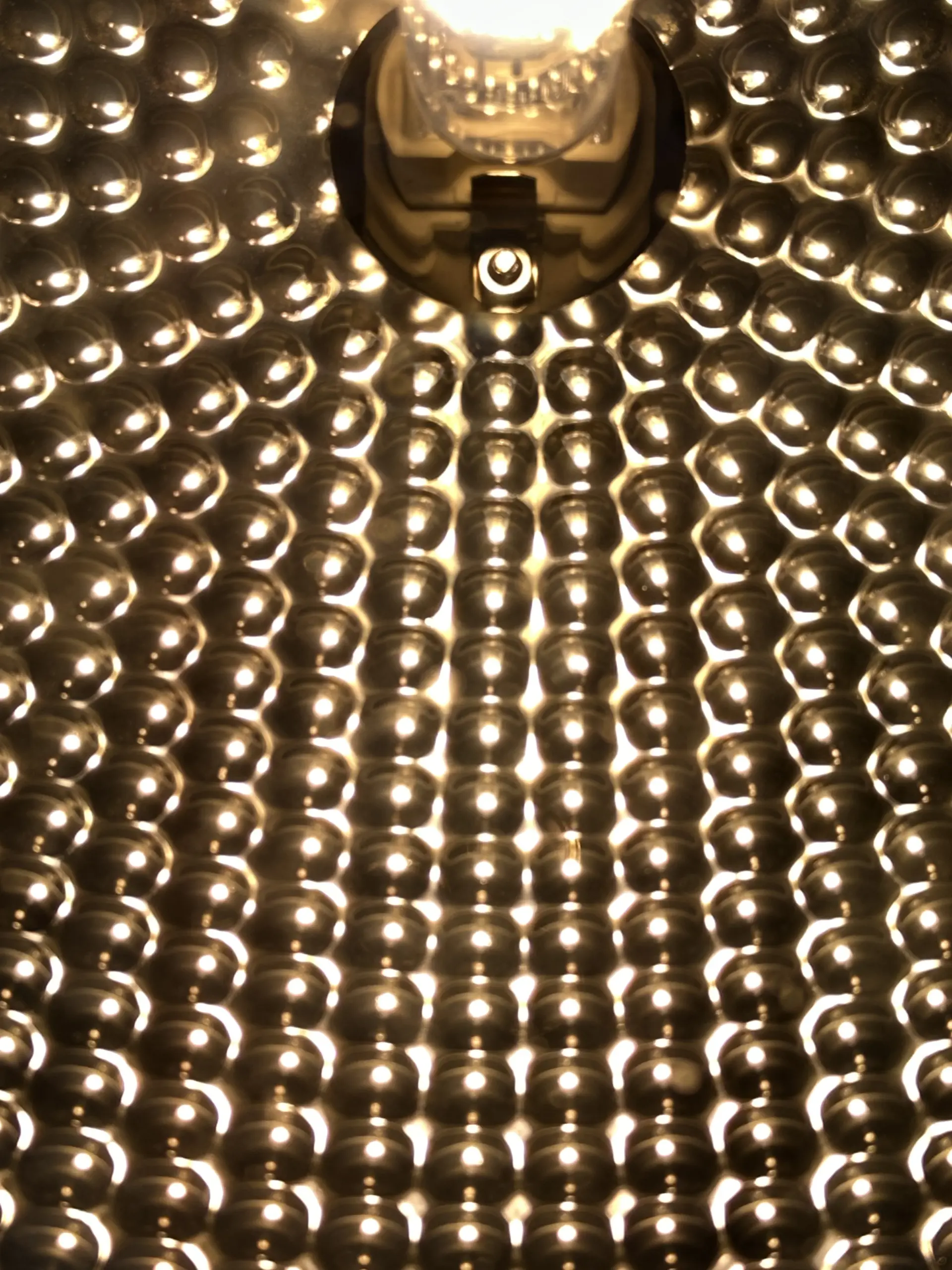 Photograph of the Nano Grow Light reflector illuminated, showing the lamp and repeated reflective cells; visual documentation only